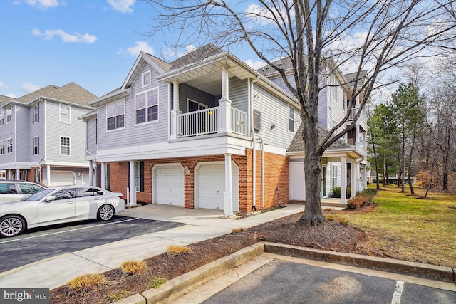 view of front of property with brick siding, an attached garage, and a balcony