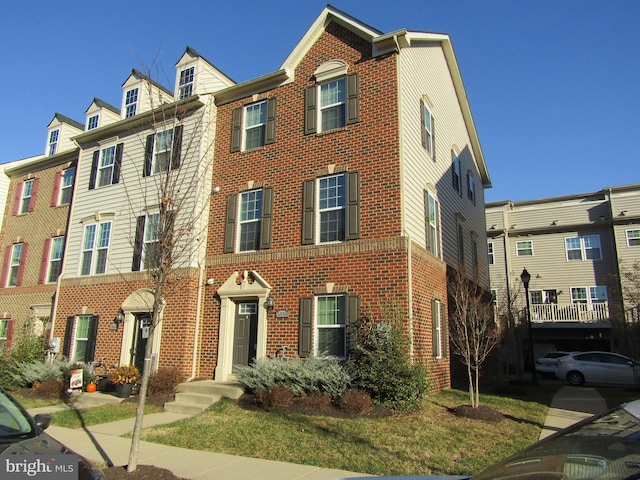 townhome / multi-family property featuring brick siding