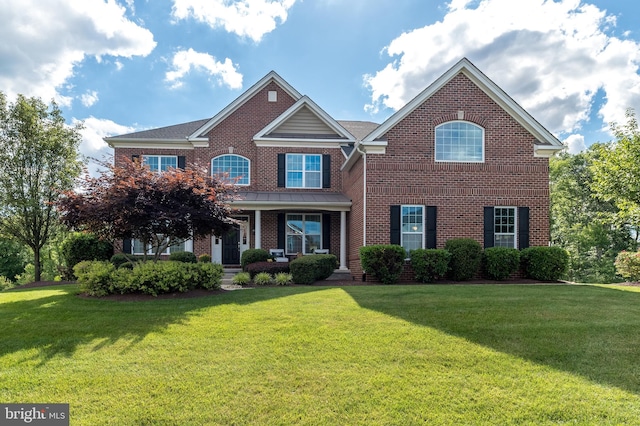 view of front of property with a front yard and brick siding