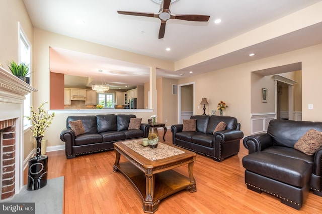 living area with visible vents, light wood-style flooring, a fireplace, recessed lighting, and ceiling fan