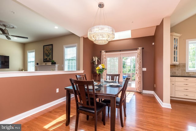 dining space featuring recessed lighting, baseboards, light wood-style floors, and ceiling fan with notable chandelier