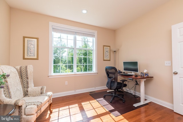 home office featuring visible vents, baseboards, and wood finished floors