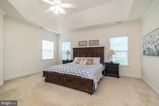 bedroom featuring a tray ceiling, light colored carpet, and baseboards