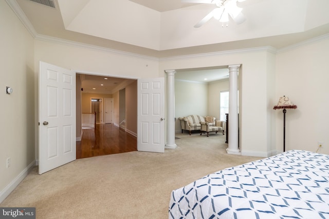 carpeted bedroom featuring baseboards, crown molding, and ornate columns