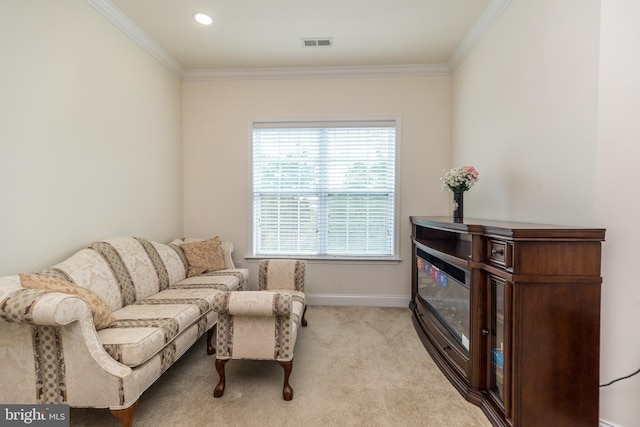 sitting room with visible vents, carpet floors, baseboards, and ornamental molding