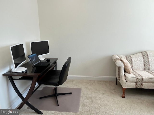 carpeted office space featuring baseboards