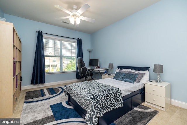 carpeted bedroom with baseboards, visible vents, and ceiling fan