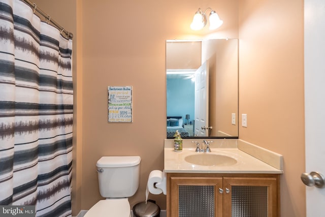 ensuite bathroom with toilet, ensuite bath, and vanity