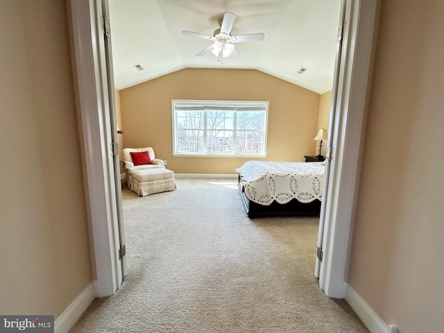 bedroom with baseboards, light carpet, visible vents, and vaulted ceiling