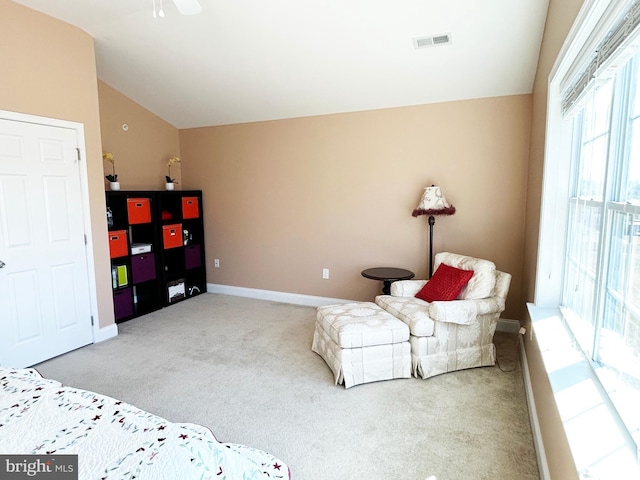 sitting room featuring visible vents, carpet floors, baseboards, and vaulted ceiling