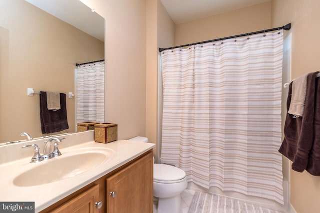 full bathroom featuring vanity, toilet, and tile patterned flooring