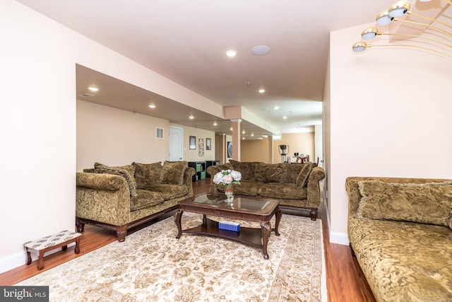 living room with visible vents, recessed lighting, baseboards, and wood finished floors