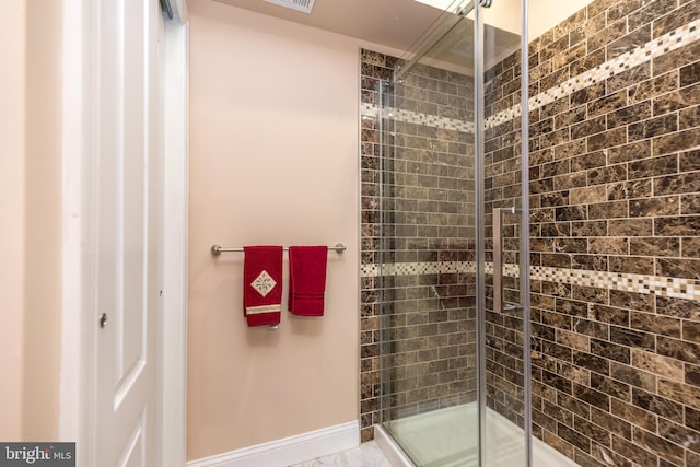 bathroom with visible vents, baseboards, and a shower stall