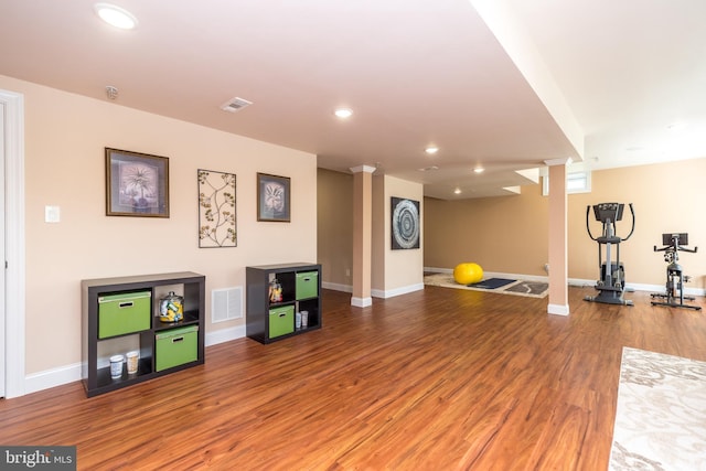 exercise room with recessed lighting, visible vents, baseboards, and wood finished floors