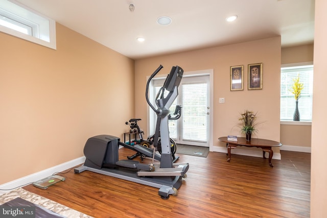 workout area featuring recessed lighting, wood finished floors, and baseboards