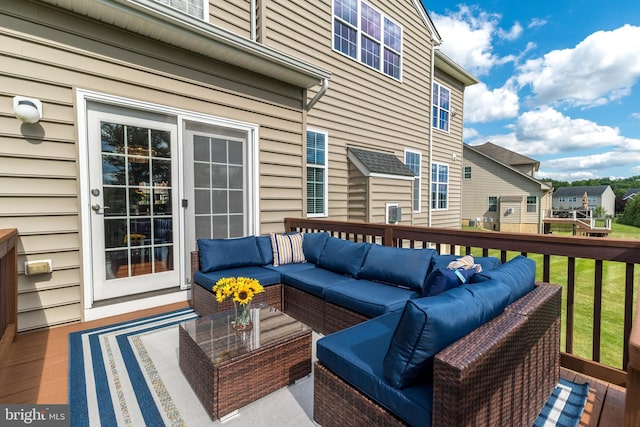 wooden terrace with an outdoor living space, a yard, and a residential view