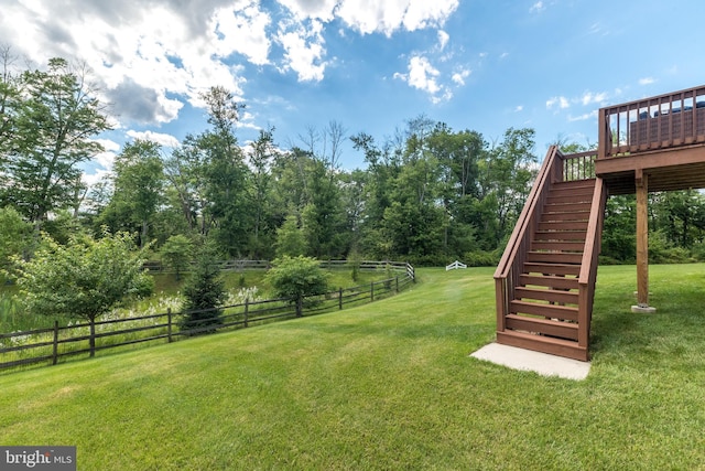 view of yard with stairs, fence, and a wooden deck