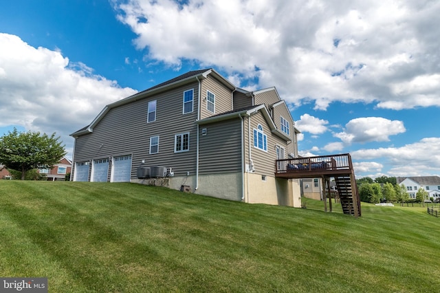 back of house with central AC unit, stairs, a garage, a deck, and a lawn