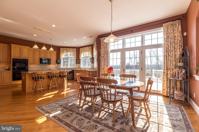 dining area featuring recessed lighting, a healthy amount of sunlight, and light wood finished floors