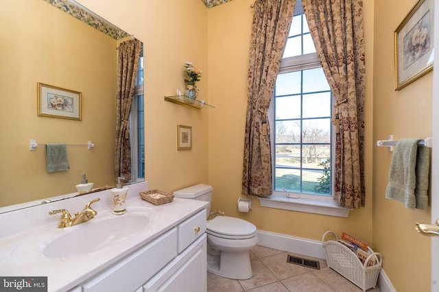 bathroom featuring tile patterned floors, visible vents, toilet, baseboards, and vanity