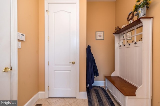 mudroom featuring baseboards and light tile patterned flooring