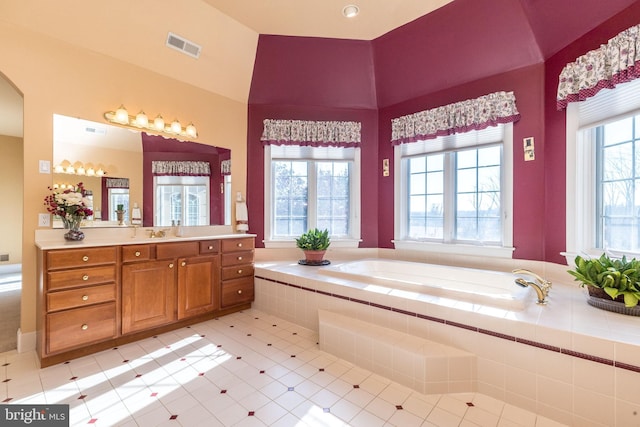 full bathroom featuring vanity, a bath, and visible vents