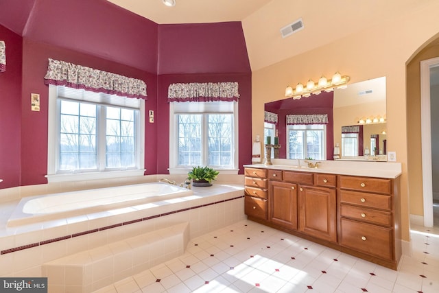 full bathroom with vanity, a bath, and visible vents