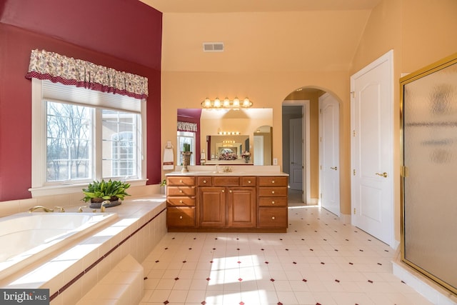 full bathroom featuring visible vents, a shower stall, vanity, and a garden tub