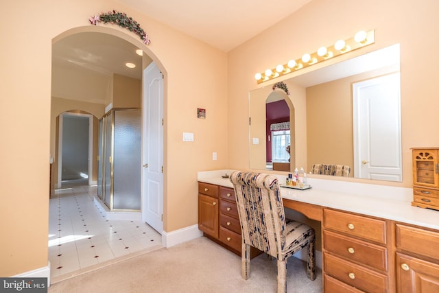 full bath with tile patterned floors, a shower stall, vanity, and baseboards