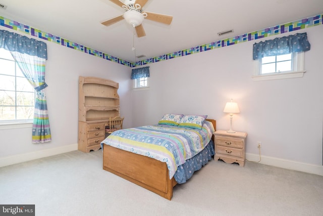 bedroom with visible vents, multiple windows, and carpet