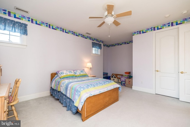 carpeted bedroom featuring baseboards, multiple windows, and visible vents