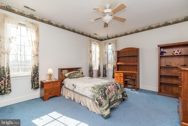 carpeted bedroom featuring a ceiling fan, baseboards, and visible vents