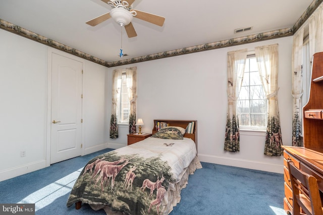 carpeted bedroom featuring visible vents, a ceiling fan, and baseboards