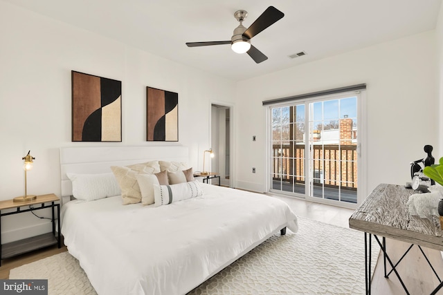 bedroom with baseboards, visible vents, ceiling fan, wood finished floors, and access to exterior