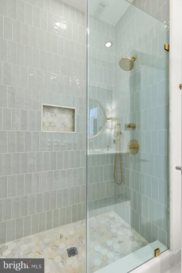 full bath featuring a shower stall and visible vents