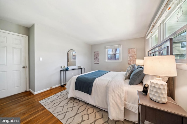 bedroom featuring wood finished floors and baseboards