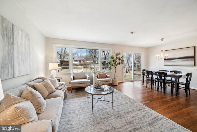 living area featuring a chandelier and wood finished floors