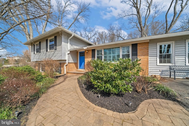 tri-level home with brick siding