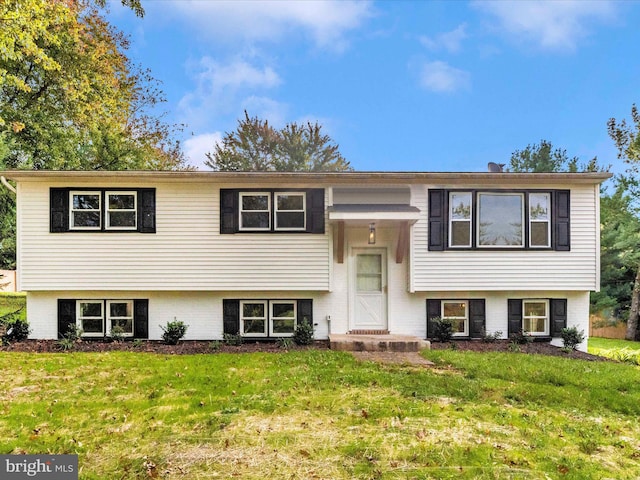 raised ranch featuring a front yard