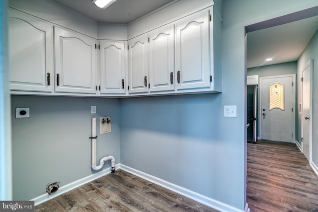 laundry area featuring cabinet space, dark wood-type flooring, gas dryer hookup, electric dryer hookup, and baseboards