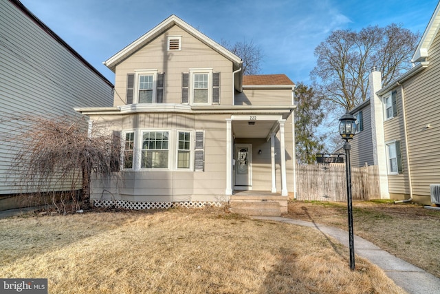 traditional home featuring fence