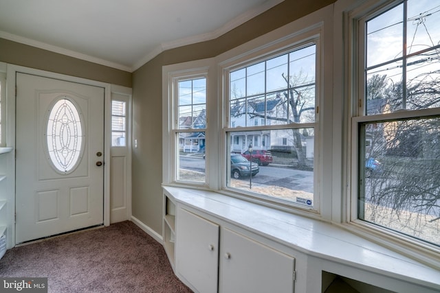 carpeted entrance foyer featuring crown molding