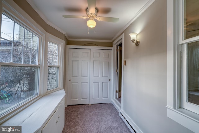 carpeted bedroom featuring baseboards, a baseboard radiator, ornamental molding, and a closet