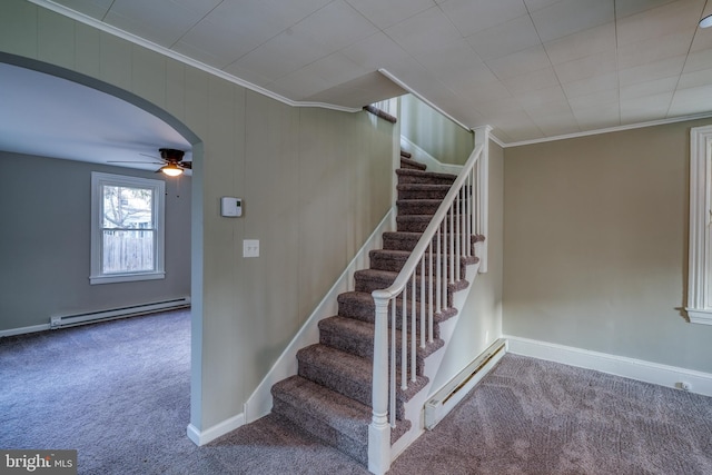 stairs with arched walkways, ornamental molding, baseboard heating, and carpet