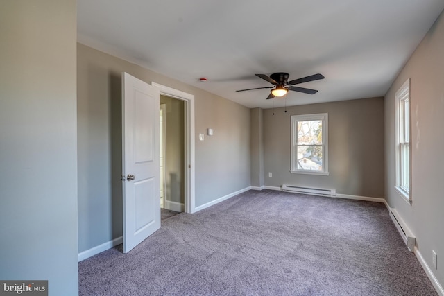 spare room with baseboards, a baseboard heating unit, ceiling fan, and carpet flooring