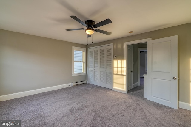 unfurnished bedroom featuring a baseboard radiator, a ceiling fan, baseboards, a closet, and carpet