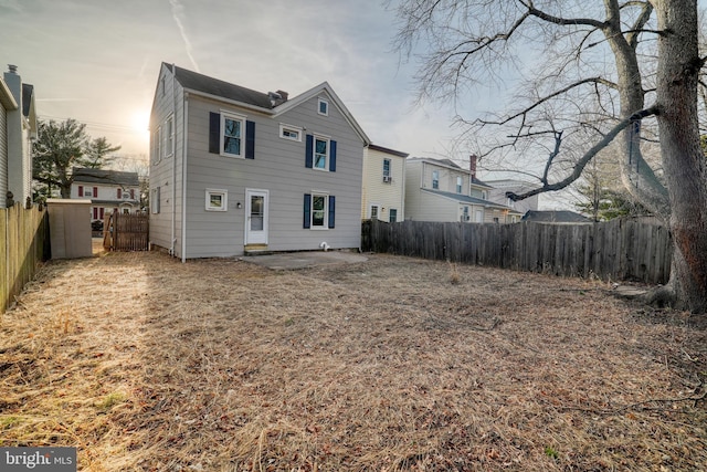 rear view of property with a patio area and a fenced backyard