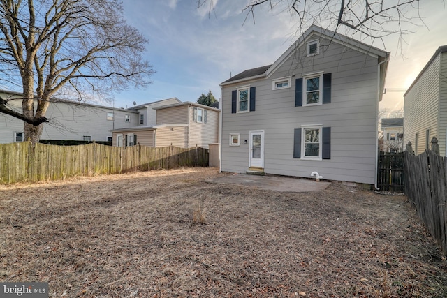 back of house featuring fence