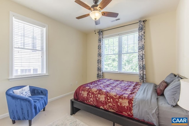 bedroom featuring a ceiling fan, baseboards, visible vents, and carpet flooring