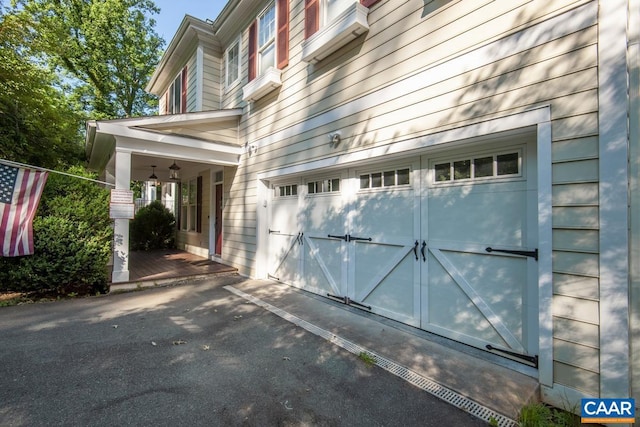 view of home's exterior with a garage and aphalt driveway